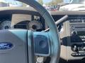 Interior view of a 2013 Ford Expedition dashboard showing the steering wheel instrument cluster and center controls