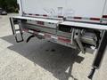 A folded liftgate attached to the rear of a 2022 International MV607 truck showcasing metallic components and a safety handle