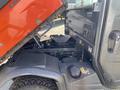 A 2018 Kubota RTV-X 1100 C utility vehicle with its hood lifted revealing the engine compartment and internal components