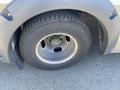 Close-up of a wheel from a 2020 Chevrolet Express showing the tire tread and the rim with lug nuts
