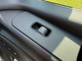 Detail of a control switch for the window of a 2023 Mercedes-Benz Sprinter featuring a rectangular button with an icon of a window being raised or lowered