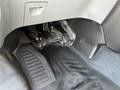 The interior floor of a 2016 Ford Transit showing rubber floor mats and pedals for the accelerator and brake