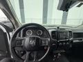 Interior view of a 2016 RAM 1500 showcasing the steering wheel and dashboard with controls and gauges