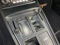 The interior control panel of a 1972 Chevrolet Corvette featuring dials switches and a gear lever