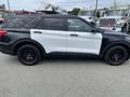 A 2021 Ford Explorer with a black and white color scheme and black wheels parked in a lot