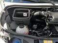 A 2020 Mercedes-Benz Sprinter engine compartment showing various components including an air filter box a fluid reservoir and several hoses