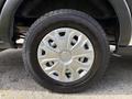 Close-up of a 2021 Ford Transit wheel featuring a silver rim with several spokes mounted on a black tire