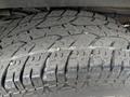Close-up of a tire tread from a 2013 Chevrolet Express showing deep grooves and worn rubber pattern