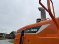 Close-up of a 2018 Doosan DL300-5 loader showcasing its orange exterior and distinctive model markings