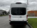 A white 2021 Ford Transit van viewed from the rear with a large back window and the model name "TRANSIT 350 HD XLT" displayed on the rear door