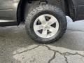 A close-up of a tire on a 2015 RAM 1500 featuring rugged tread and a silver alloy wheel