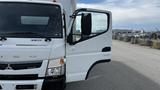 A 2018 Mitsubishi Fuso FE truck with an open driver's door showcasing its white exterior and front details