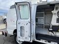 2008 Ford Econoline van with an open side door revealing a partially empty interior with shelves and equipment