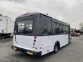 A 2017 Chevrolet Express bus with a white body and gray roof features large side windows and a rear door, designed for passenger transport