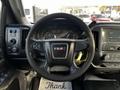 Steering wheel of a 2017 GMC Sierra 3500HD featuring controls and the GMC logo with instrument cluster visible in the background