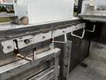 A 2016 Ford F-550 with various metal hooks and mounts installed in the truck bed area
