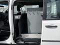 Interior view of a 2011 Dodge Grand Caravan showing a gray divider with hooks mounted on it inside the vehicle's rear passenger area