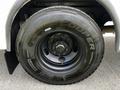 Close-up of a large black tire labeled Cooper mounted on a metal wheel of a 2022 Blue Bird BB Conventional bus
