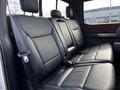 A 2021 Ford F-150 features a spacious back seat with black leather upholstery and headrests on each seat