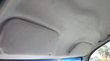 The interior ceiling of a 2006 Ford F-650 showing the fabric material and overhead sun visors