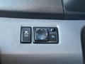 Control panel featuring buttons for traction control and power door windows in a 2017 Nissan NV200