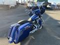 A 2017 Harley-Davidson FLHXS motorcycle in blue with a sleek design and chrome accents featuring a large front fairing and saddlebags