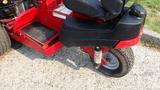 2014 Ferris Mower ISX 800 with a red body and a black seat featuring a suspension system and rear wheel on a turf-friendly tire