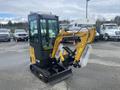 A 2024 AGT Industrial H13R Mini Excavator in black and yellow with a protective cover on the arm and a bucket attachment, sitting on tracks, ready for operation
