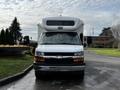 A 2017 Chevrolet Express featuring a white exterior with a prominent black grille and Chevy emblem in the center