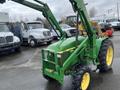A green 2003 John Deere 790 tractor with a front loader attachment and yellow wheels