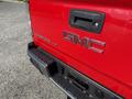 A red 2018 GMC Canyon truck with the brand logo and model name visible on the tailgate