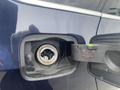 Close-up of the fuel filler cap of a 2009 BMW X5 showing the opening and fuel line mechanism