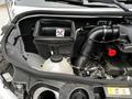 Close-up of the engine compartment of a 2023 Mercedes-Benz Sprinter showing the air filter housing and various components like the coolant reservoir and intake hoses