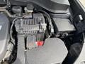 Engine compartment of a 2015 Kia Sorento featuring various components including the engine cover and several electrical connectors