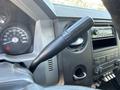 The steering wheel and control stalk of a 2012 Ford F-450 SD with clear gauges and dashboard controls visible in the foreground