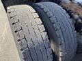 Close-up of two truck tires from a 2022 Freightliner Cascadia showing different levels of wear with one tire appearing more worn than the other