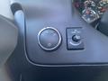 The image shows the control panel of a 2012 GMC Savana featuring a dial for headlight settings and a switch for interior dome light control.
