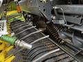 A close-up view of a 2020 Pottinger Impress machine showcasing its intricate metal components and tines used for agricultural purposes