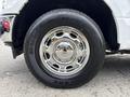 A close-up view of a chrome wheel on a 2018 Ford F-150 showing the tire tread and shiny rim