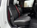 A 2024 RAM 5500 with black leather seating in the rear cabin featuring red seatbelt accents and spacious seating arrangement
