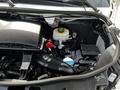Engine compartment of a 2019 Mercedes-Benz Sprinter featuring various components like the air intake system coolant reservoir and battery