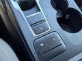 Close-up of the center console of a 2020 Ford Escape showing control buttons for parking and drive features with cup holders visible