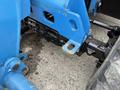 Close-up of a blue Genie GTH-5519 telehandler's undercarriage showcasing mechanical components and connectors
