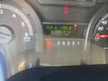 The dashboard display of a 2009 Ford Econoline showing trip information and total kilometers driven