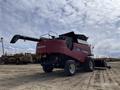 A red 2014 Versatile RT490 combine harvester with large tires and a raised grain auger on the rear