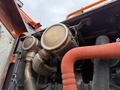 Close-up of the engine components of a 2018 Doosan DL300-5 including exhaust and piping with visible wear and rust