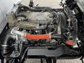 Engine of a 2022 Isuzu NPR showing various components including hoses and metal parts in a detailed view