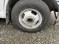 A close-up view of a wheel from a 2017 Chevrolet Express featuring a silver metal rim and a black tire with visible tread markings