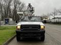 A 2004 Ford F-450 SD with a mounted utility platform on the roof facing forward