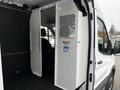 A 2021 Ford Transit van with a partition wall separating the driver's seat from the cargo area